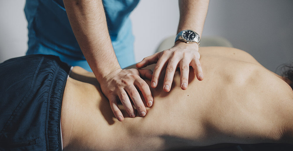 Close up of Therapist Massaging Lower Back