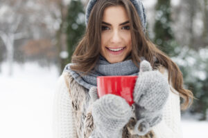 Winter woman with cup of hot tea